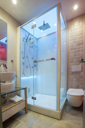 a bathroom with a shower with a toilet and a sink at Mariet Athens Boutique Spa in Athens