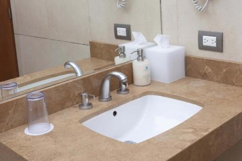 a bathroom counter with a sink and a mirror at Casa Andina Select Zorritos Tumbes in Zorritos