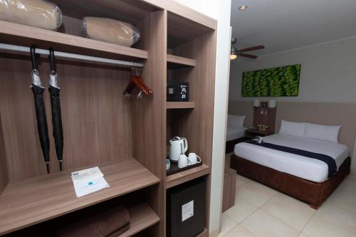 a small bedroom with a bed and a room with a bed sqor at Casa Andina Select Zorritos Tumbes in Zorritos