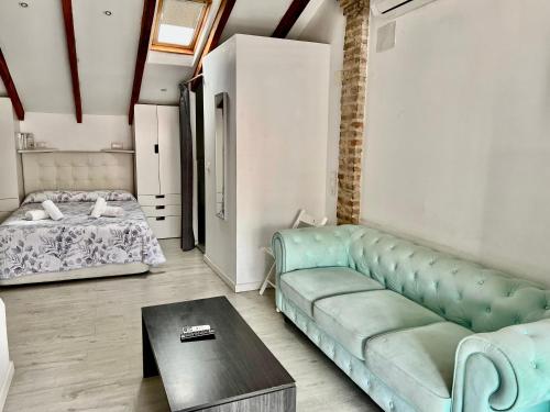 salon z kanapą i łóżkiem w obiekcie Precioso estudio con terraza privada en la playa w Walencji