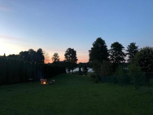 a field with a fire in the grass at Domek Letniskowy Krejwince in Krejwińce