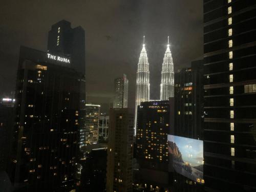 a view of the kuala lumpur city skyline at night at 8 Kia Peng Central Suites in Kuala Lumpur