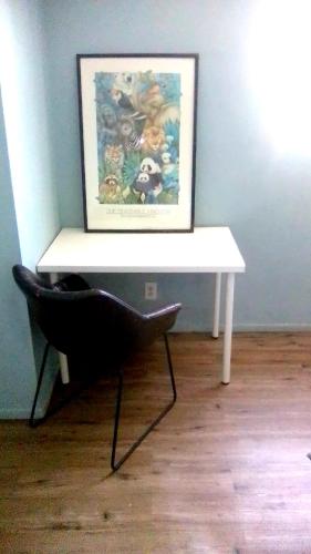 a white table in a room with a picture on the wall at Los Angeles Zen Home in Los Angeles