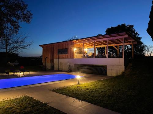 a house with a swimming pool at night at Landhaus dasThomas in Henndorf 