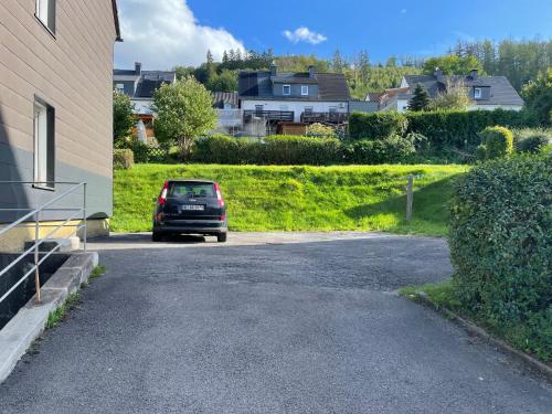 a car parked on the side of a driveway at FeWo Roll 2 in Plettenberg