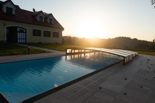a large swimming pool in front of a house at Landhaus dasThomas in Henndorf 