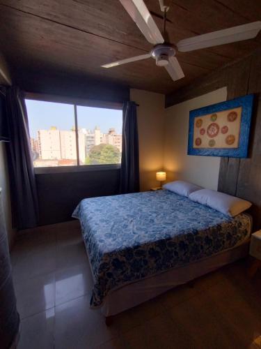 a bedroom with a bed and a large window at Jujuy 303 y Piedras in San Miguel de Tucumán