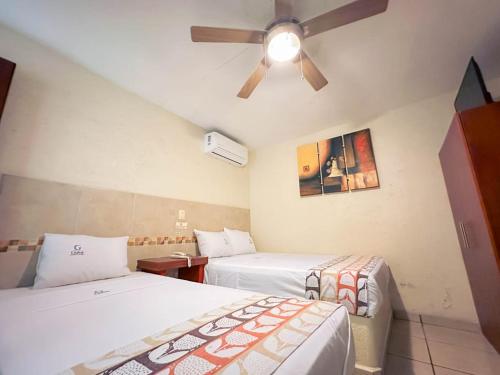 Postel nebo postele na pokoji v ubytování Hotel Guivá Huatulco