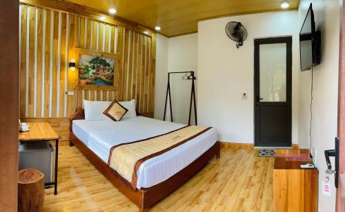 a bedroom with a bed and a television in it at Trang An Memory Homestay in Ninh Binh