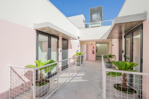 a balcony of a building with potted plants at La Moderna by Wynwood House in Panama City