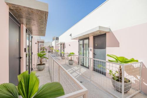a balcony of a house with potted plants at La Moderna by Wynwood House in Panama City