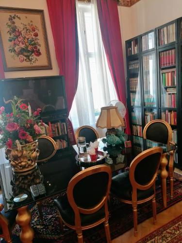 a living room with a table and chairs and books at Luxury near Castle in Vienna