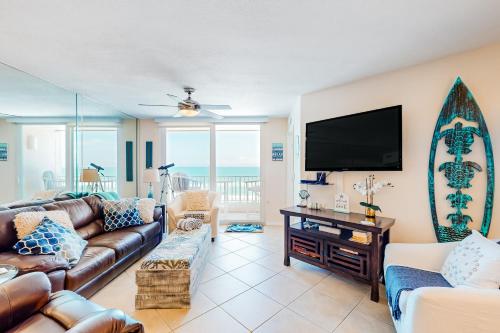 a living room with a couch and a flat screen tv at By The Sea Turtles in Ponce Inlet
