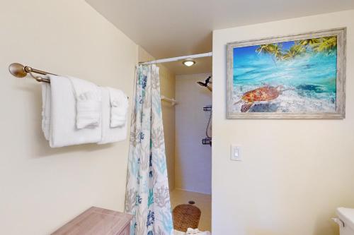 a bathroom with a shower with a picture of a turtle at By The Sea Turtles in Ponce Inlet