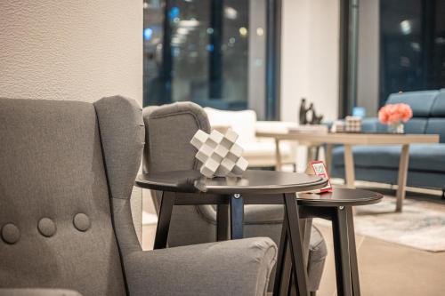 a room with two chairs and a table with a box on it at Pyramisa Hotel Apartments in Dubai