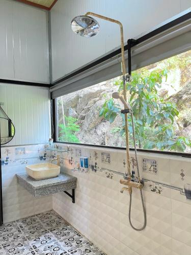a bathroom with a shower and a sink at Trang An Memory Homestay in Ninh Binh