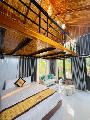 a bedroom with a large bed with a wooden ceiling at Trang An Memory Homestay in Ninh Binh