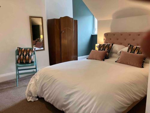 a bedroom with a large white bed and a mirror at Inviting 3-Bed House in Sunderland WiFi Parking in Sunderland