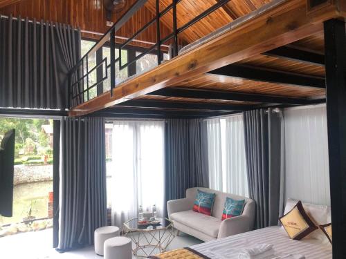 a bedroom with a loft with a bed and a chair at Trang An Memory Homestay in Ninh Binh
