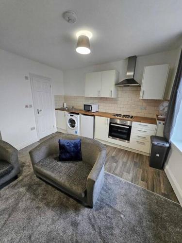 a living room with a couch and a kitchen at 11 Croft - Room 4 in Neath