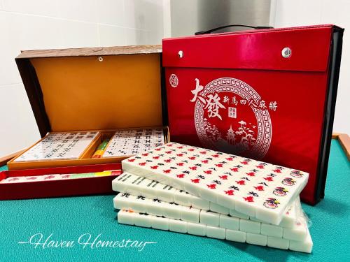 a box of books sitting next to a box ofizza at Haven Homestay晶晶屋 (Brand New Homestay!) in Kampong Sungai Udang