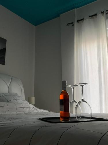 a bottle of whiskey on a tray on a bed at Dream Central Appartment in Thessaloniki
