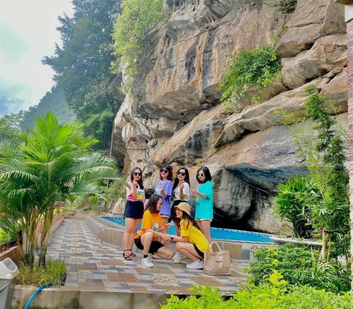 a group of girls posing for a picture in front of a mountain at Trang An Memory Homestay in Ninh Binh