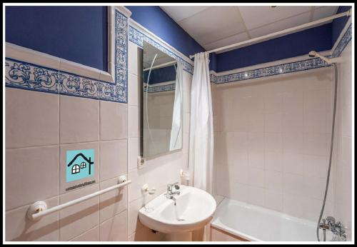a bathroom with a sink and a toilet and a mirror at Villas Cañada in Torrox Costa