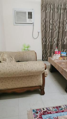 a living room with a couch and a air conditioner at An appartment for rent in Ajman Alreqah Building in Ajman 