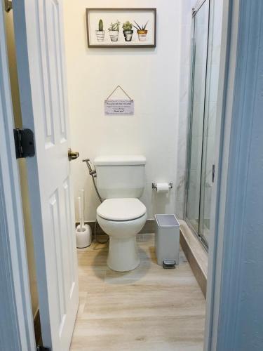 a bathroom with a toilet and a glass shower at Nuvole Guest Suite in Miami