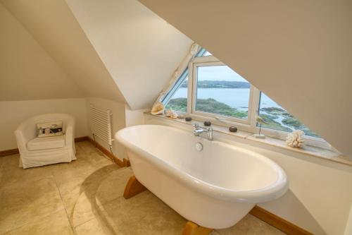 a bathroom with a sink and a large window at House on the Beach in Valley
