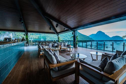 a restaurant with couches and tables and a view of the water at H Hotel El Nido - Vegan Friendly Hotel in El Nido