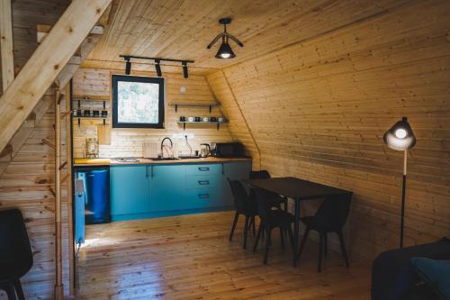 a kitchen and dining room in a log cabin at Peak view kazbegi in Stepantsminda