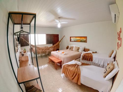 a hotel room with two beds and a shower at Apt Flat 225 Condomínio Pedra do Rodeadouro in Bonito