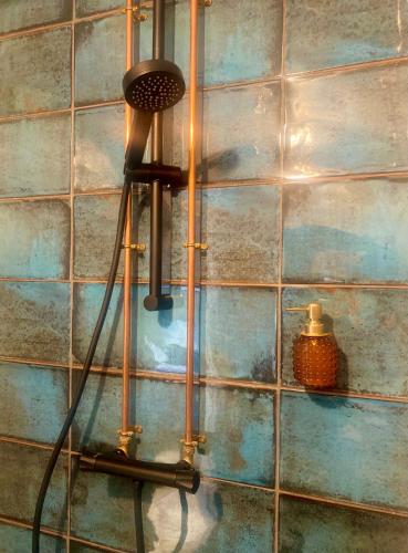 a lamp in a room with a blue tiled wall at Sleep Hotel in Worthing