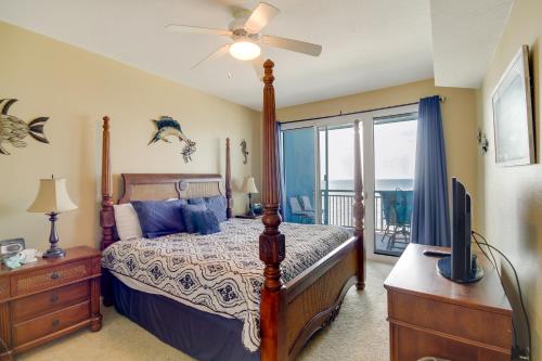 a bedroom with a bed and a tv and a window at Beachfront Gulfport Vacation Rental with Balcony! in Gulfport