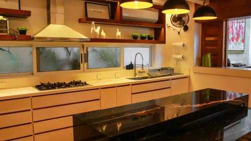 a kitchen with a sink and a counter top at Esciros in Chicxulub