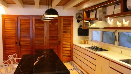 a kitchen with wooden cabinets and a counter top at Esciros in Chicxulub
