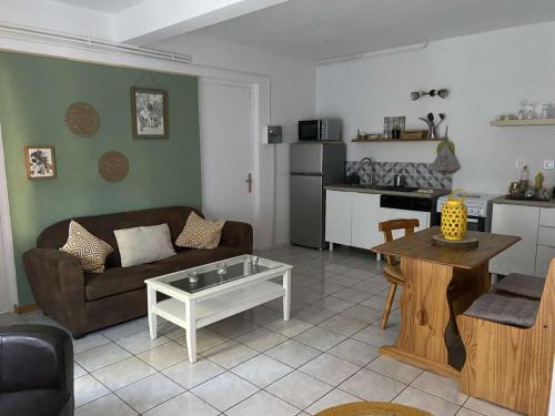 a living room with a couch and a table at Gîte du vieux moulin in Ravilloles