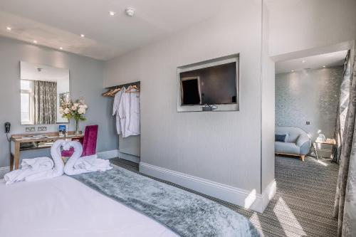 a bedroom with a bed with two swans on it at Muthu Westcliff Hotel (Near London Southend Airport) in Southend-on-Sea