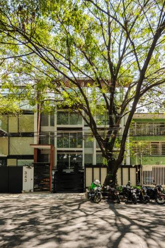 a group of motorcycles parked in front of a building at Allan Poe 343 by Wynwood House in Mexico City