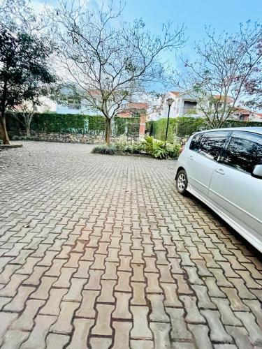 a white car parked on a brick driveway at Khael Glory home offers 247 security in Kampala