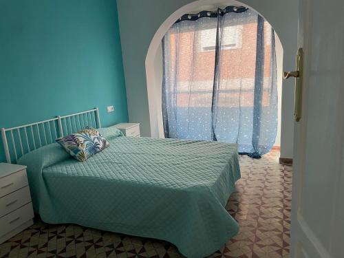 a bedroom with a bed and a large window at Casa sebas in Puerto de Mazarrón