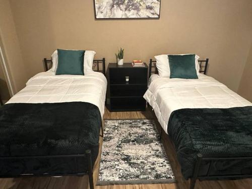 two beds sitting next to each other in a room at 2BR Condo 15 mins to Downtown Phoenix with Pool & Spa in Phoenix