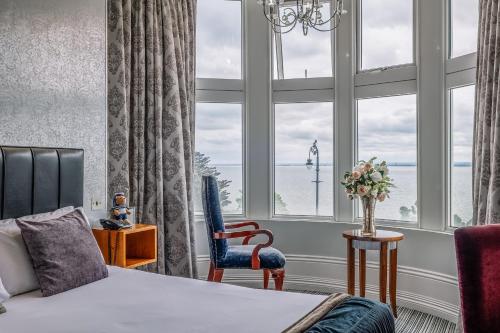 a hotel room with a bed and a large window at Muthu Westcliff Hotel (Near London Southend Airport) in Southend-on-Sea