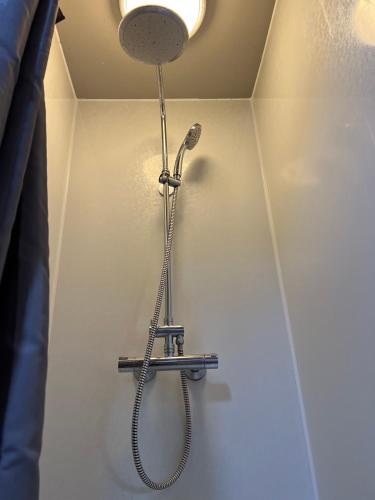 a shower in the corner of a room at Apartment dome Hof í Vatnsdal in Blönduós