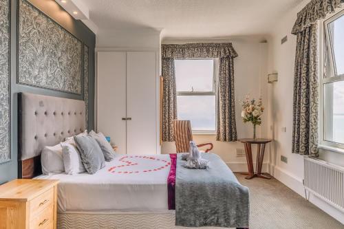 a bedroom with a large bed and a window at Muthu Westcliff Hotel (Near London Southend Airport) in Southend-on-Sea