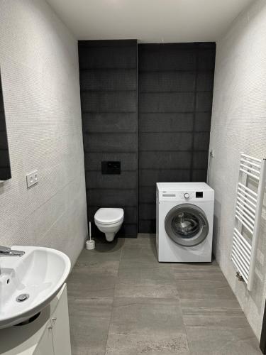 a bathroom with a washing machine and a toilet at Byt apartman 73m2 for 4people ALL NEW! 2023 in Prague