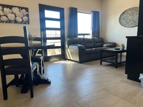 a living room with a couch and a table at Playas Hotel Suites in Puerto Peñasco