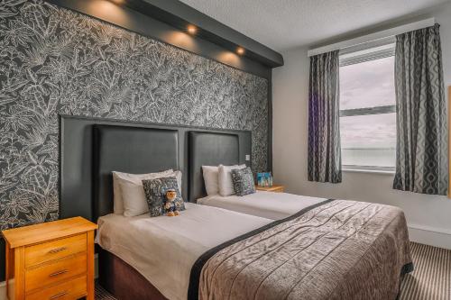 a bedroom with two beds and a window at Muthu Westcliff Hotel (Near London Southend Airport) in Southend-on-Sea
